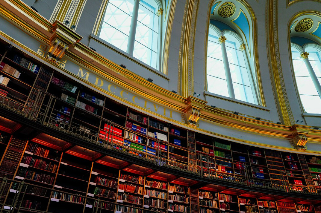Tall library bookshelves in a historic reading room